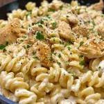 Close-up of creamy garlic Parmesan chicken pasta served in a bowl.