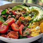 A colorful Hearty Breakfast Scramble Bowl featuring eggs, vegetables, and avocado.