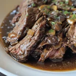 Close-up view of a succulent balsamic glazed roast beef with mushrooms.