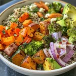 A vibrant quinoa and roasted veggie bowl featuring colorful vegetables and grains.