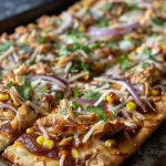 Close-up view of a BBQ Chicken Flatbread Pizza topped with melted cheese and fresh cilantro.