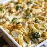 Close-up of a Chicken and Broccoli Alfredo Bake with melted cheese topping.