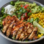Close-up view of a colorful chicken taco bowl filled with rice, beans, corn, and fresh vegetables.