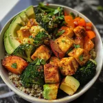A close-up view of a Spiced Tofu and Roasted Veggie Quinoa Bowl with vibrant vegetables and tofu.