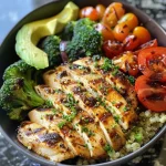 Juicy grilled chicken served in a colorful veggie bowl with fresh ingredients.
