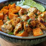 Close-up of a colorful Chicken and Sweet Potato Bowl featuring cubed chicken and sweet potatoes.