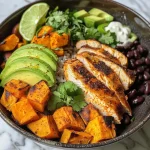 Close-up view of a Chicken Sweet Potato Rice Bowl featuring colorful ingredients.