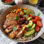A side view of a quinoa bowl featuring grilled chicken, avocado, and vibrant vegetables.