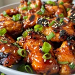 Close-up view of juicy honey garlic chicken thighs with a glossy glaze.