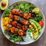 A close-up side view of a colorful BBQ Chicken Skewer Salad Bowl, showcasing vibrant ingredients.