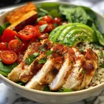 A close-up view of a colorful Chicken Quinoa Power Bowl featuring diced chicken, quinoa, and fresh vegetables.