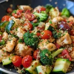 Close-up side view of a Chicken Quinoa Skillet filled with colorful ingredients.