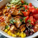 Close-up of a Copycat Chipotle Chicken Burrito Bowl with vibrant ingredients.