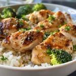 Close-up view of creamy garlic chicken rice bowl with broccoli.