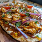 Juicy BBQ chicken flatbread topped with mozzarella, cheddar, cherry tomatoes, and red onion.