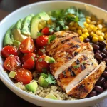 Close-up view of a high-protein chicken quinoa power bowl with vibrant ingredients.