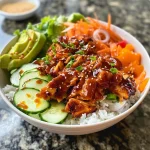A close-up view of a Korean BBQ chicken rice bowl with vibrant colors and fresh ingredients.