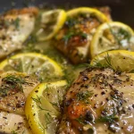 Juicy lemon dill chicken thighs garnished with fresh dill.