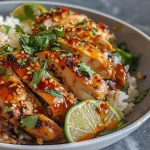Juicy Spicy Maple Chicken served on a bed of fluffy coconut rice.