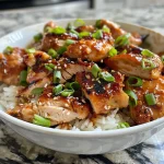 Juicy Sweet Chili Air Fryer Chicken Thighs garnished with green onions and sesame seeds.