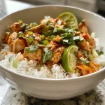 Close-up view of a Sweet Chili Chicken Bowl topped with a coconut lime drizzle.