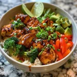 Close-up of a mouthwatering Hot Honey Chicken Bowl featuring juicy chicken, rice, and colorful vegetables.