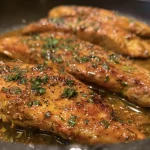 ['Juicy Cajun Butter Chicken Breasts garnished with herbs on a plate.', 'Close-up of succulent Cajun Chicken Breasts with a buttery glaze.', 'Horizontal slice of Cajun Butter Chicken showcasing spices and juices.', 'Plate of Cajun Butter Chicken with a side of herbs and garlic.']