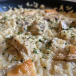 ['Close-up of a creamy Chicken and Rice Casserole with chunks of chicken and rice.', 'Side view of Chicken and Rice Casserole showing its layered ingredients.', 'Juicy Chicken and Rice Casserole featuring a golden-brown top and creamy texture.', 'A dish of Chicken and Rice Casserole, highlighting the succulent chicken pieces.']