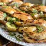 ['A close-up view of grilled chili-lime chicken sandwiches with potato wedges on the side.', 'Juicy grilled chicken sandwiches topped with coleslaw, avocado, and served with crispy potato wedges.', 'A side view of a delicious grilled chicken sandwich, garnished with lime and jalapeño, alongside potato wedges.', 'A vibrant presentation of chili-lime chicken sandwiches and golden potato wedges on a wooden platter.']