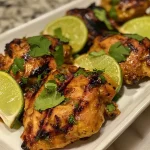 ['Juicy grilled curry chicken with a golden-brown crust, garnished with fresh cilantro.', 'Close-up of succulent grilled chicken pieces marinated in curry spices with a side view shot.', 'Flavorful grilled chicken breast coated in a rich curry glaze, captured from the side.', 'Tasty grilled curry chicken sitting on a plate, highlighting the marinated surface texture.']