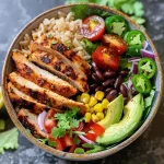 ['Close-up view of a vibrant chicken burrito bowl featuring avocado and cherry tomatoes.', 'Side shot of a healthy burrito bowl with chicken, black beans, and mixed greens.', 'Juicy chicken burrito bowl arrangement with cilantro, lime, and colorful vegetables.', 'Detailed presentation of a burrito bowl filled with chicken, corn, and fresh ingredients.']