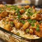 ['Close-up of a honey garlic chicken rice casserole with golden sauce and diced chicken pieces.', 'Side view of a hearty honey garlic chicken rice casserole garnished with chopped green onions.', 'Juicy chicken and rice casserole topped with a glossy honey garlic glaze in a baking dish.', 'A mouthwatering honey garlic chicken rice casserole showcasing tender chicken and rice.']