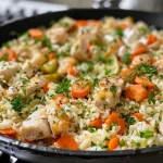 ['Close-up view of juicy chicken rice pilaf with vibrant vegetables.', 'Side angle shot of a delicious chicken rice dish garnished with parsley.', 'Detailed image of Easy Chicken Rice Pilaf featuring cooked chicken and colorful carrots.', 'Savory chicken rice pilaf served with pickles and a dollop of sour cream.']
