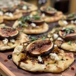 ['Close-up view of fig balsamic naan flatbreads topped with goat cheese and fresh basil.', 'Side view of naan flatbreads featuring sliced figs and melted mozzarella cheese.', 'Juicy naan flatbreads drizzled with balsamic glaze and garnished with chopped basil.', 'Delicious fig balsamic naan flatbreads showcasing vibrant toppings against a rustic background.']