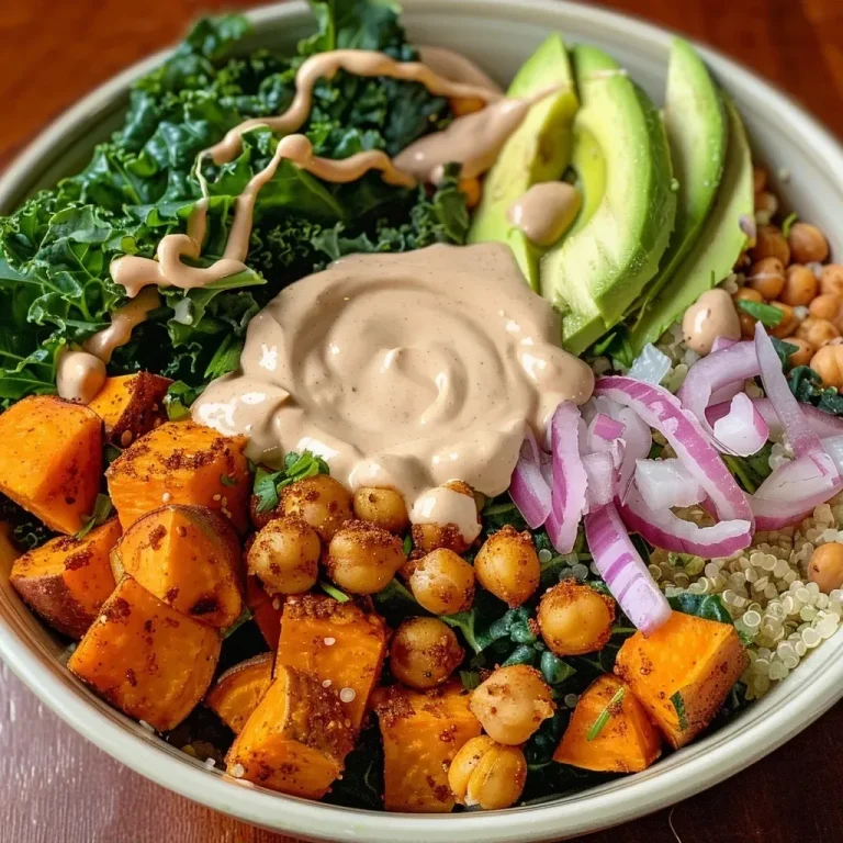 ['A colorful Vegan Sweet Potato Chickpea Buddha Bowl featuring quinoa, kale, avocado, and roasted sweet potatoes.', 'A close-up view of a nutritious Buddha Bowl filled with chickpeas, kale, and sweet potatoes, arranged artistically.', 'A vibrant vegan dish showcasing quinoa, roasted sweet potatoes, and a drizzle of lemon tahini dressing.', 'An overhead shot of a Buddha Bowl with an array of vegetables, chickpeas, and dressing, served in a bowl.']